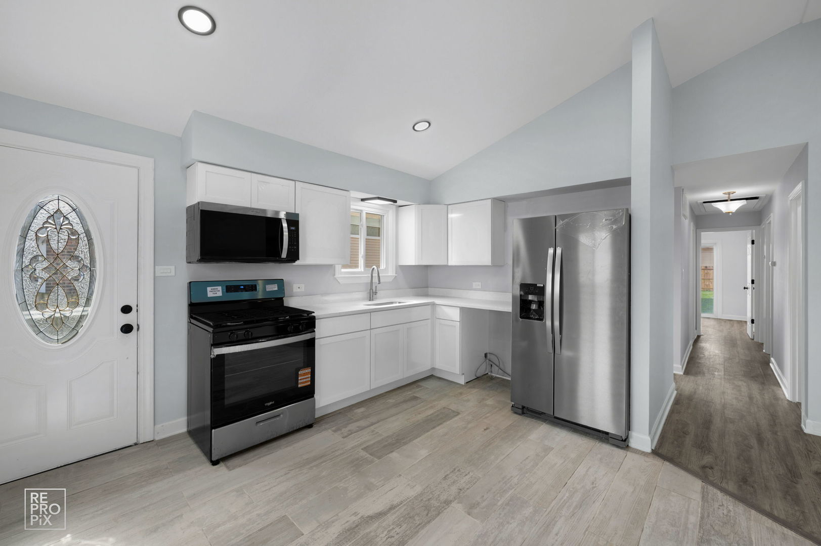 7616 South 78th Avenue Bridgeview, IL 60455 - Photo 3 of 10 a kitchen with stainless steel appliances a refrigerator stove and microwave