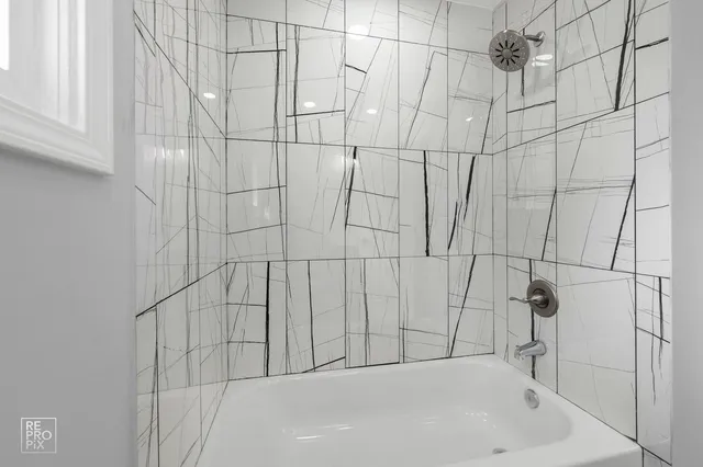 a bathroom with a white bathtub