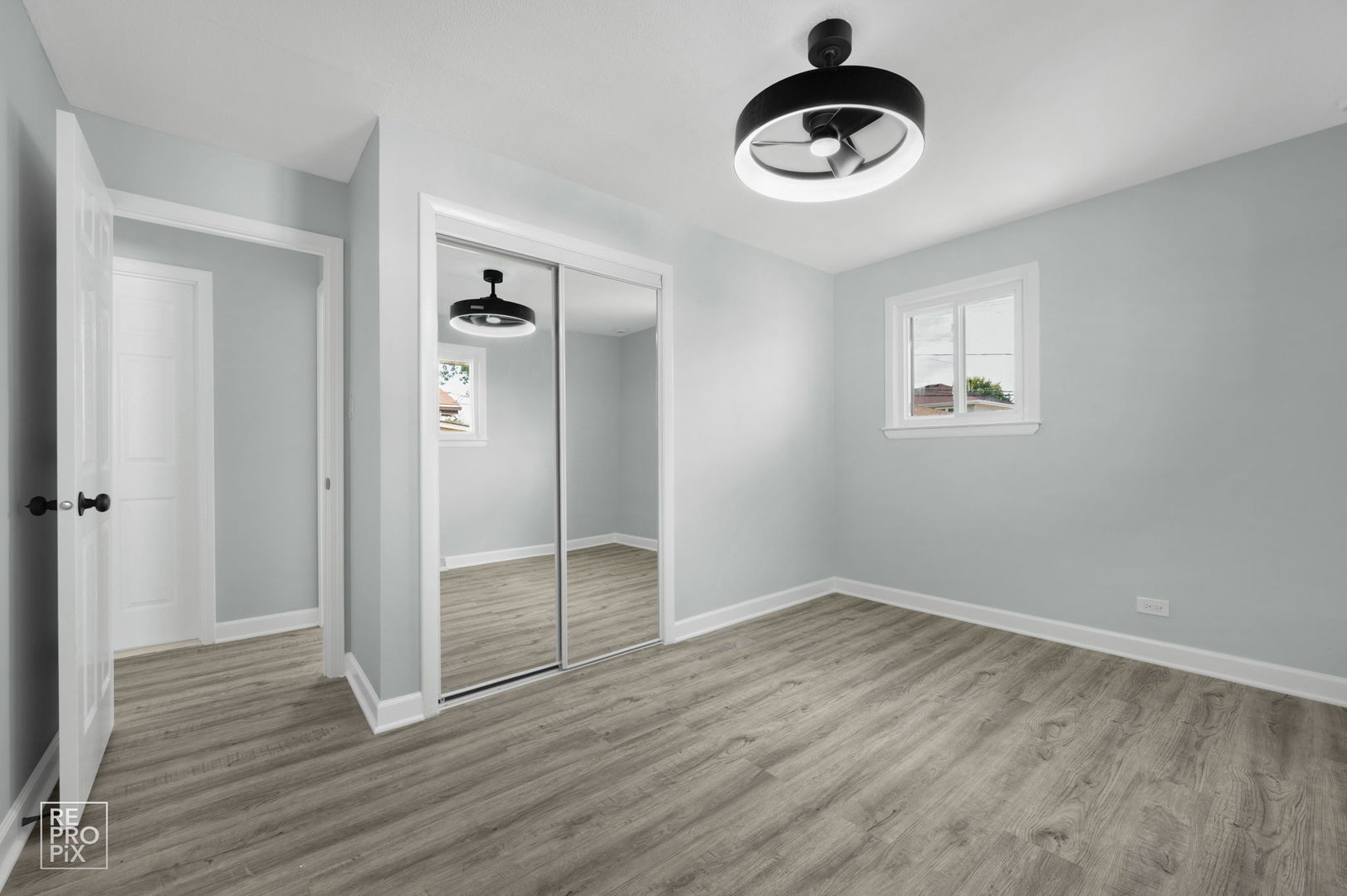 7616 South 78th Avenue Bridgeview, IL 60455 - Photo 9 of 10 a view of an empty room with wooden floor and window