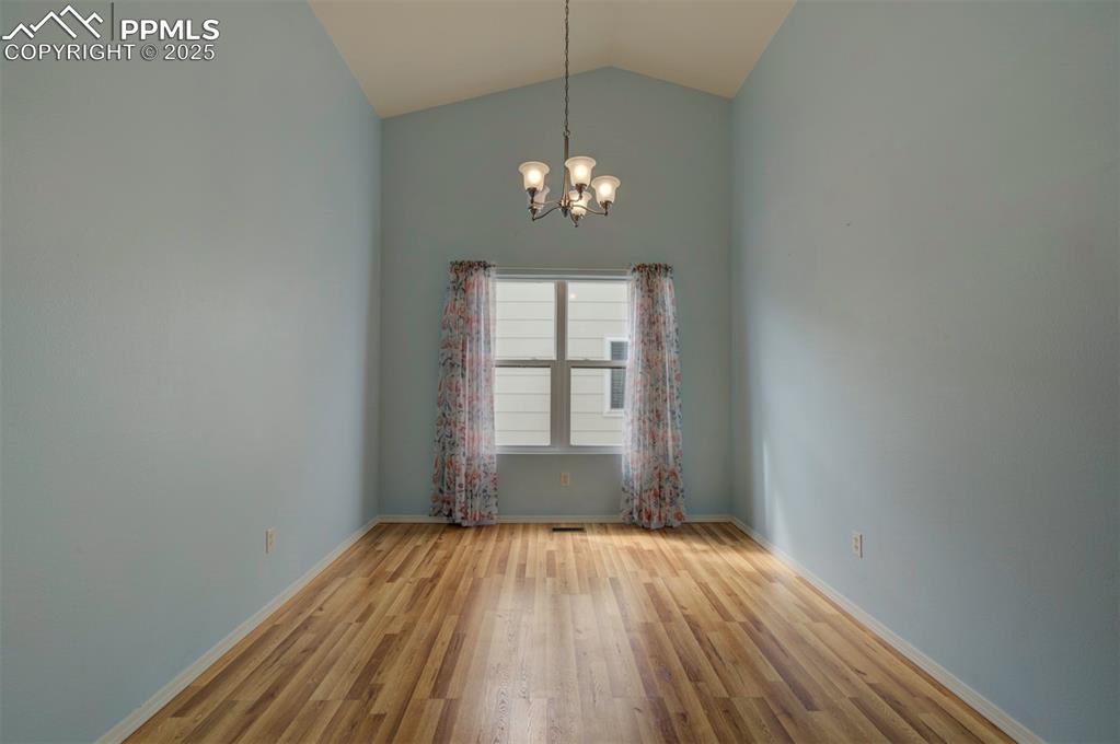 8072 Oliver Road Peyton, CO 80831 - Photo 14 of 30 a view of a room with wooden floor chandelier and a window