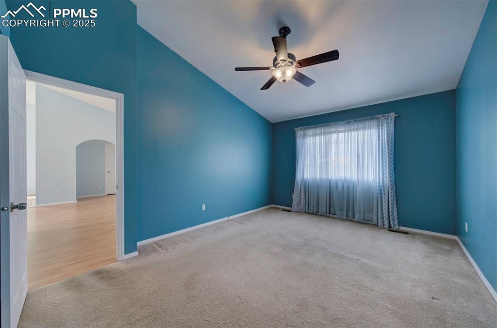 8072 Oliver Road Peyton, CO 80831 - Photo 15 of 30 a view of an empty room with windows and chandelier fan