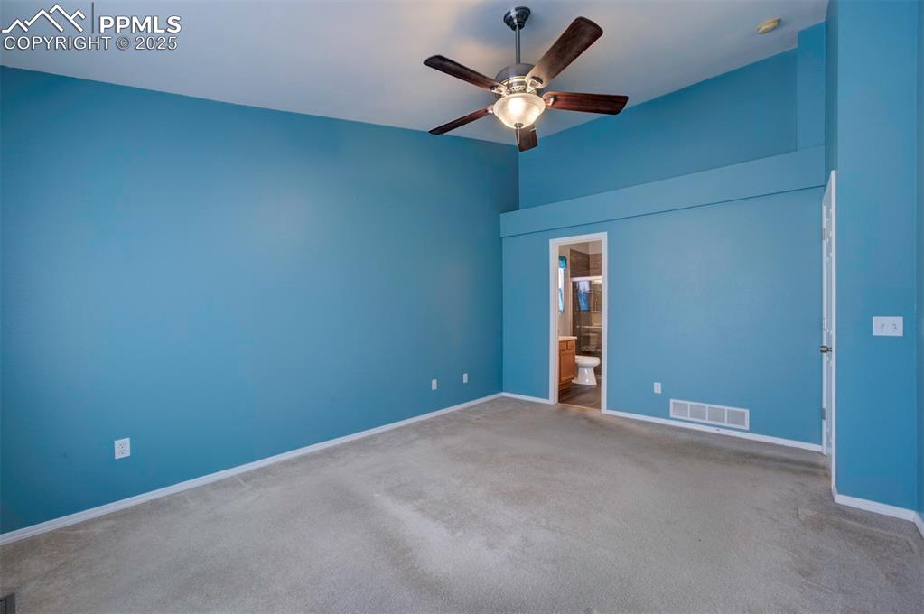 8072 Oliver Road Peyton, CO 80831 - Photo 17 of 30 a view of an empty room with a chandelier fan