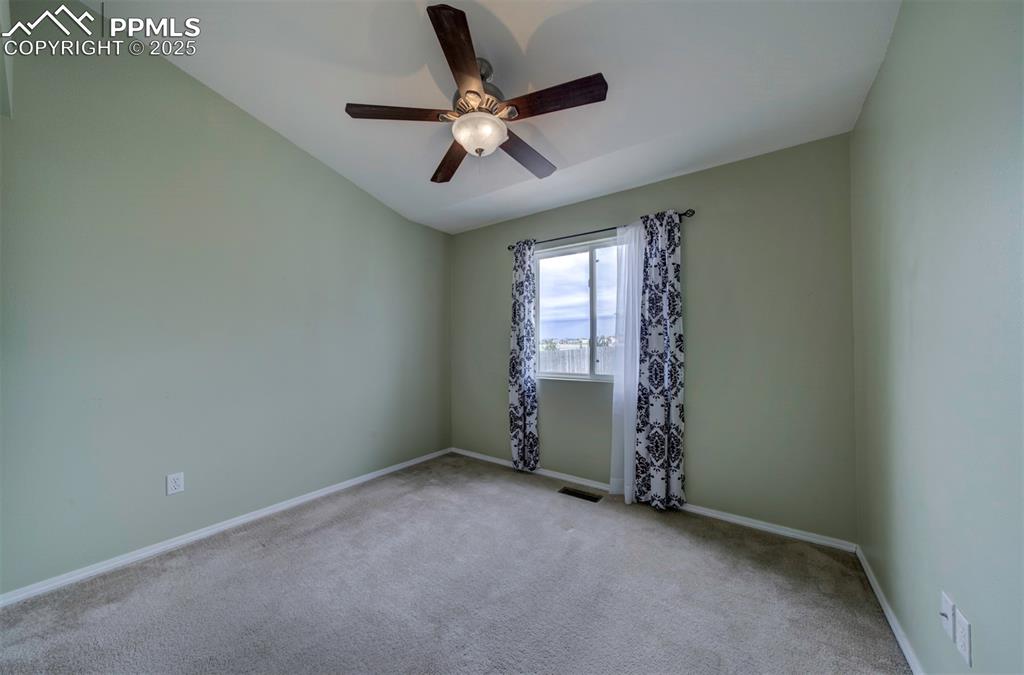 8072 Oliver Road Peyton, CO 80831 - Photo 22 of 30 an empty room with ceiling fan and window