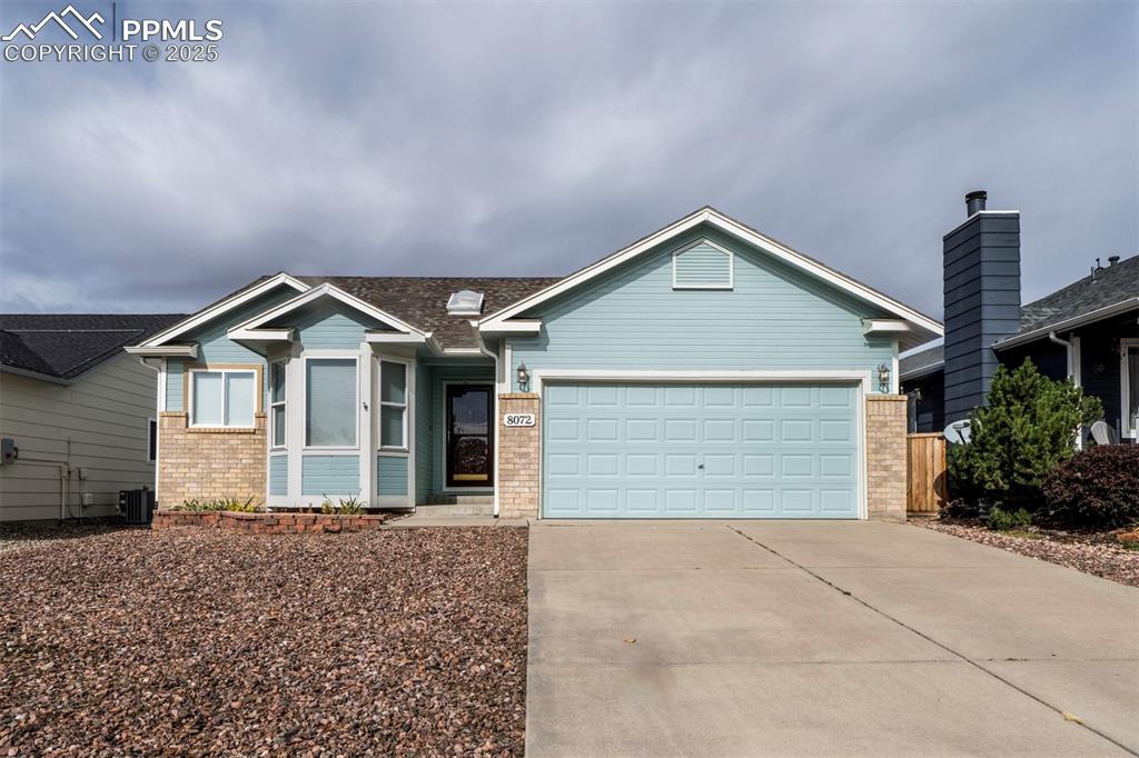 8072 Oliver Road Peyton, CO 80831 - Photo 3 of 30 a front view of a house with a yard and garage