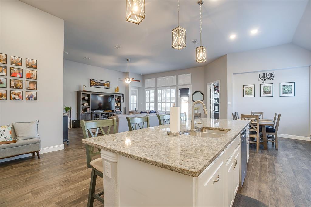 11829 Kynborrow Road Fort Worth, TX 76052 - Photo 12 of 39 a kitchen with granite countertop kitchen island stainless steel appliances a dining table and chairs