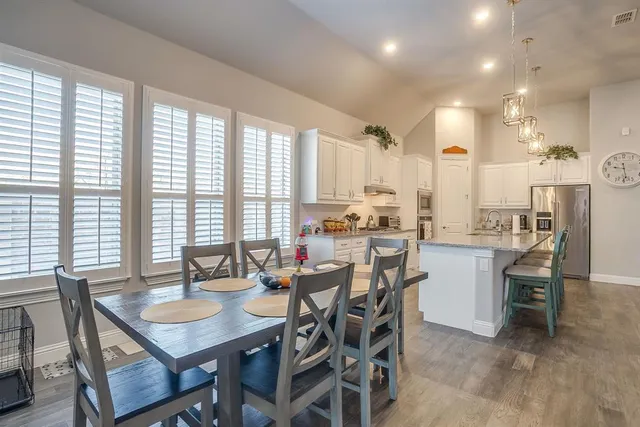 a view of a dining room with furniture and windows