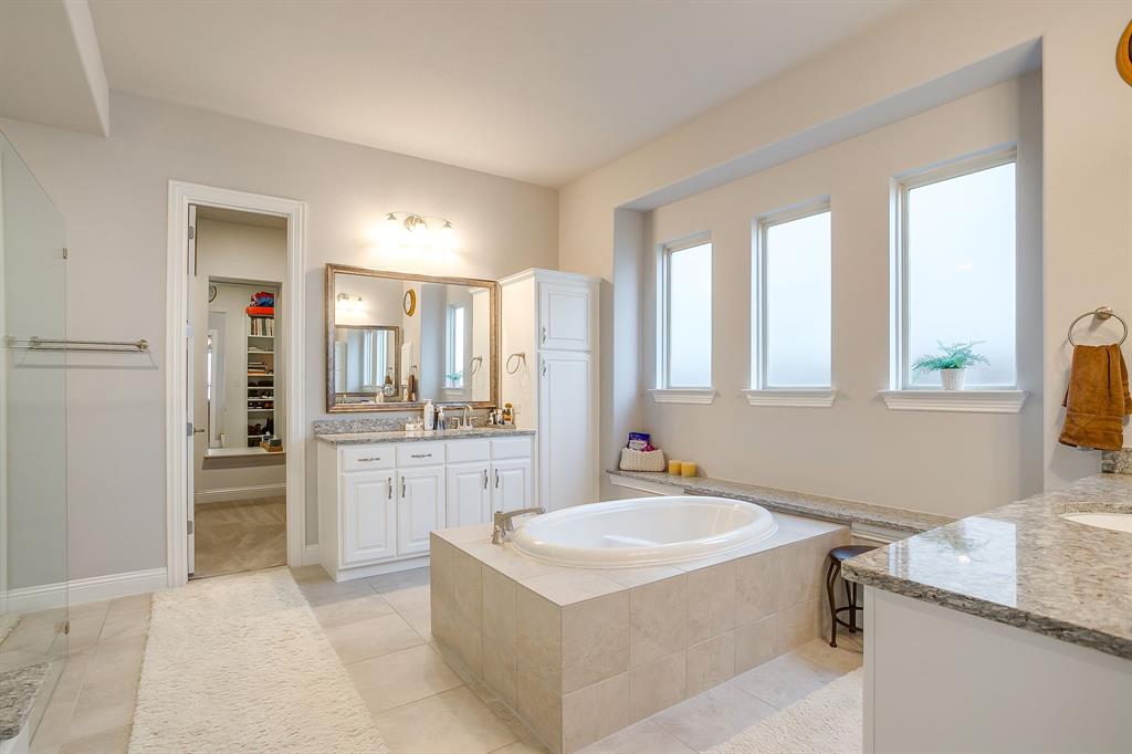 11829 Kynborrow Road Fort Worth, TX 76052 - Photo 24 of 39 a spacious bathroom with a granite countertop sink mirror and a bathtub