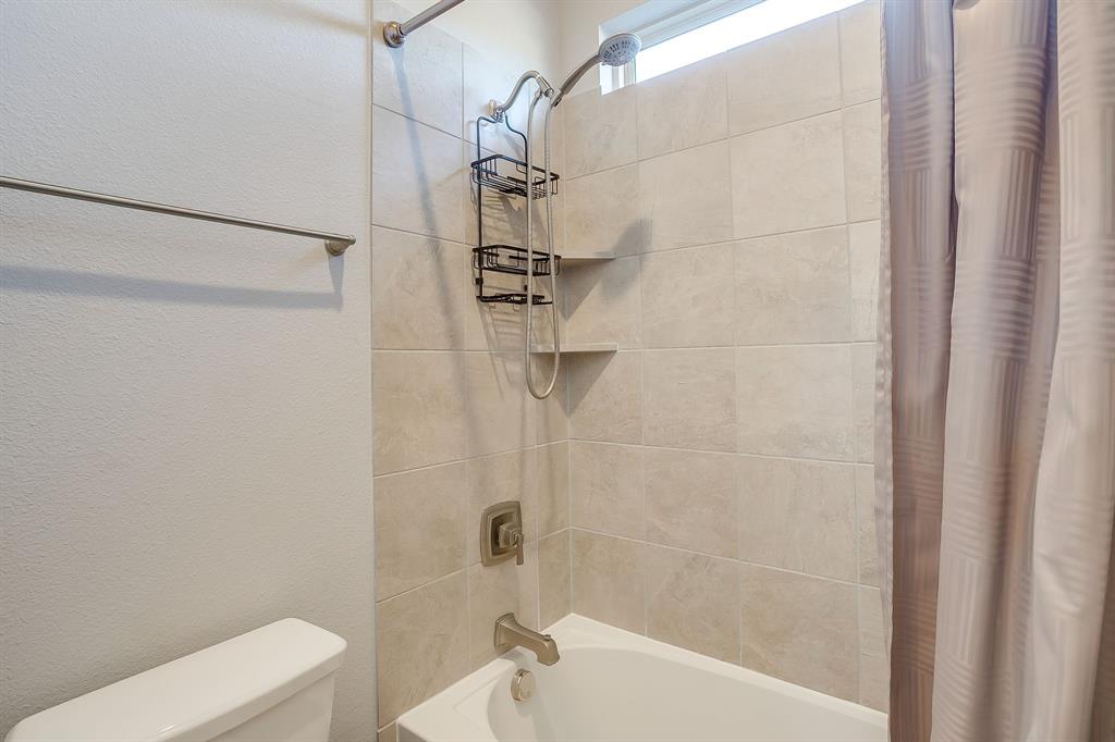 11829 Kynborrow Road Fort Worth, TX 76052 - Photo 35 of 39 a bathroom with a shower and a toilet