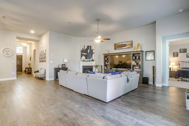a kitchen with granite countertop a sink a counter top space and living room view