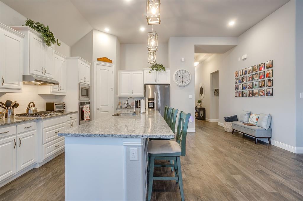 11829 Kynborrow Road Fort Worth, TX 76052 - Photo 9 of 39 a kitchen with granite countertop a sink a counter top space and living room view