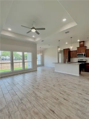 a view of a kitchen with a stove cabinets and a kitchen counter space