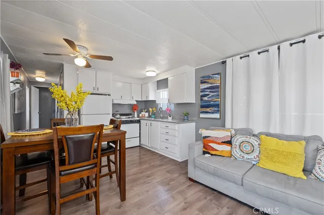 a kitchen with a table chairs refrigerator and microwave