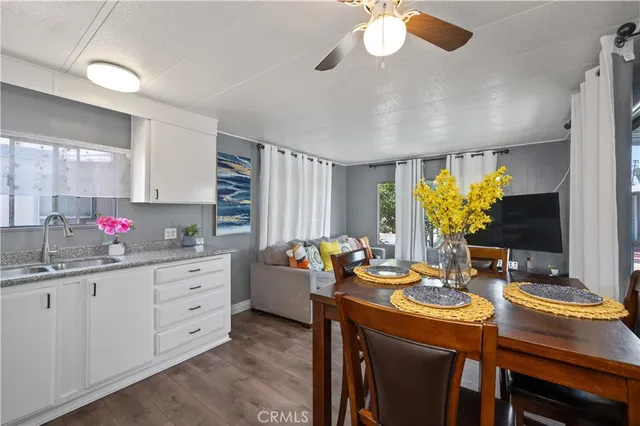 a kitchen with sink refrigerator and dining table