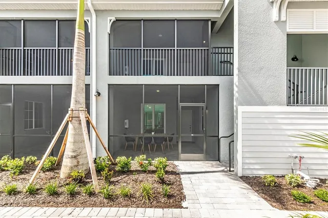 a view of a house with a small deck and wooden floor