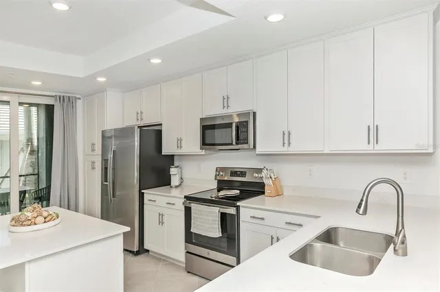 a view of a dining room with furniture and a chandelier