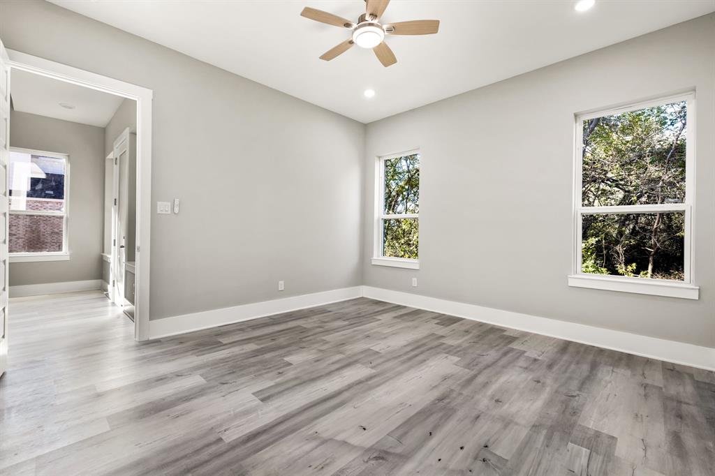 9020 Creek Run Road Fort Worth, TX 76120 - Photo 15 of 37 an empty room with window and wooden floor