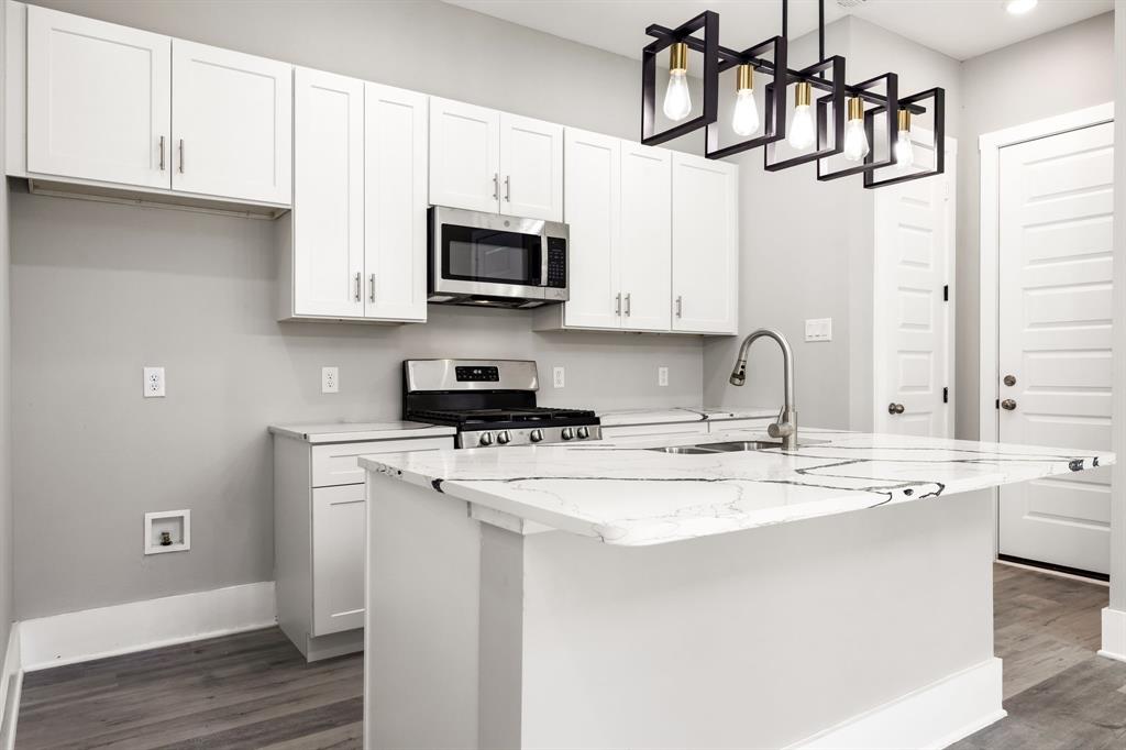 9020 Creek Run Road Fort Worth, TX 76120 - Photo 17 of 37 a kitchen with stainless steel appliances granite countertop a sink a stove and cabinets