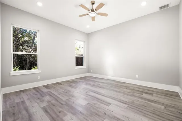 a view of a hallway with a wooden floor