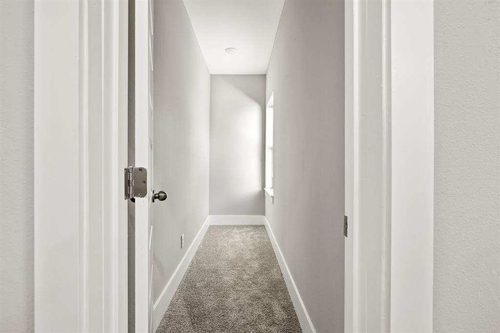 9020 Creek Run Road Fort Worth, TX 76120 - Photo 25 of 37 a view of a hallway with a wooden floor