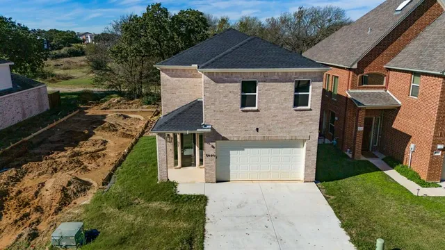 a aerial view of a house with a yard