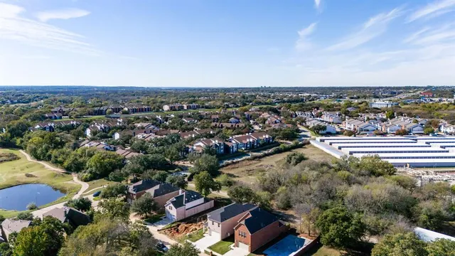 an aerial view of lake and residential houses with outdoor space