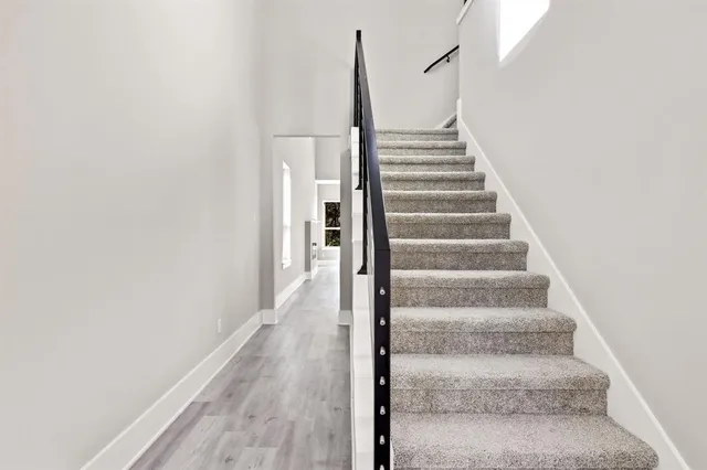 a view of staircase with white walls