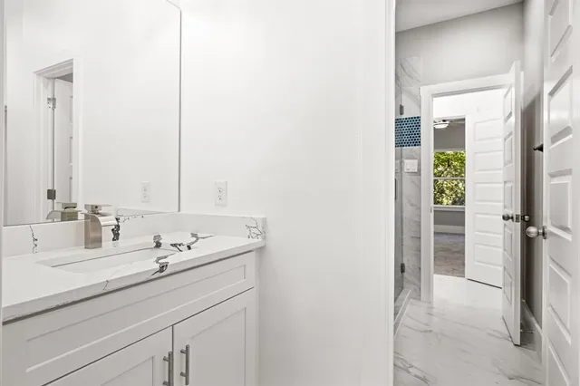 a bathroom with a double vanity sink and mirror