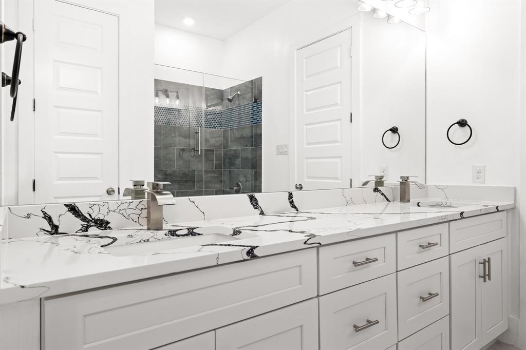 9020 Creek Run Road Fort Worth, TX 76120 - Photo 9 of 37 a bathroom with a sink and a mirror