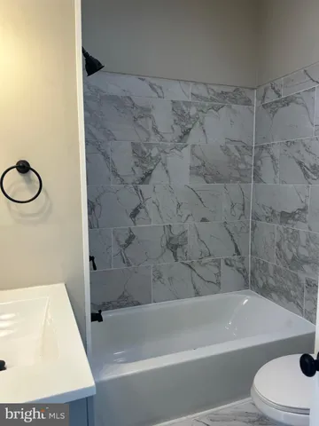 a bathroom with a bathtub and a toilet