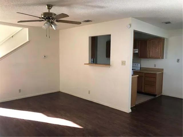 a kitchen with a refrigerator and cabinets