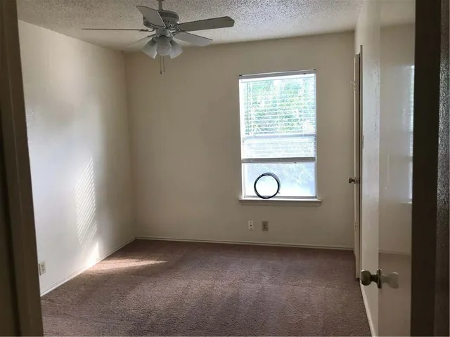 a white toilet sitting next to a shower