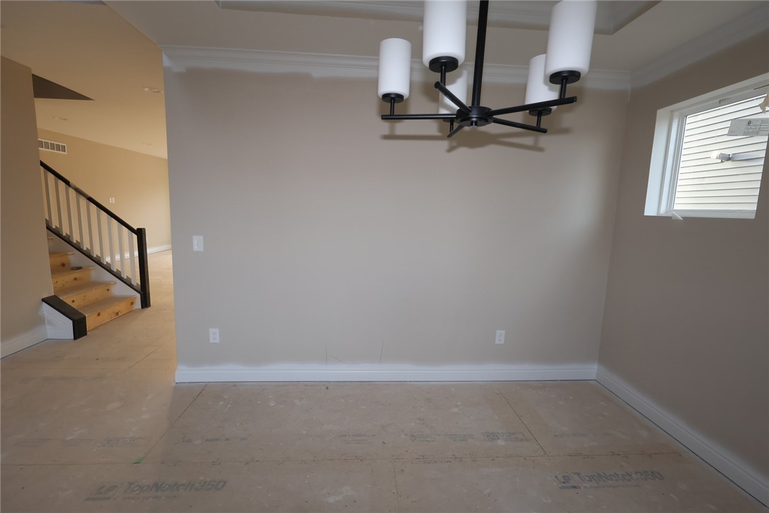 240 Tilly Court, Unit 5 Springboro, OH 45066 - Photo 8 of 26 This interior captures a room with a window, ceiling light, and a stairway.