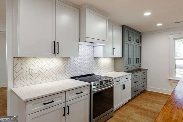 a kitchen with stainless steel appliances a sink stove and refrigerator