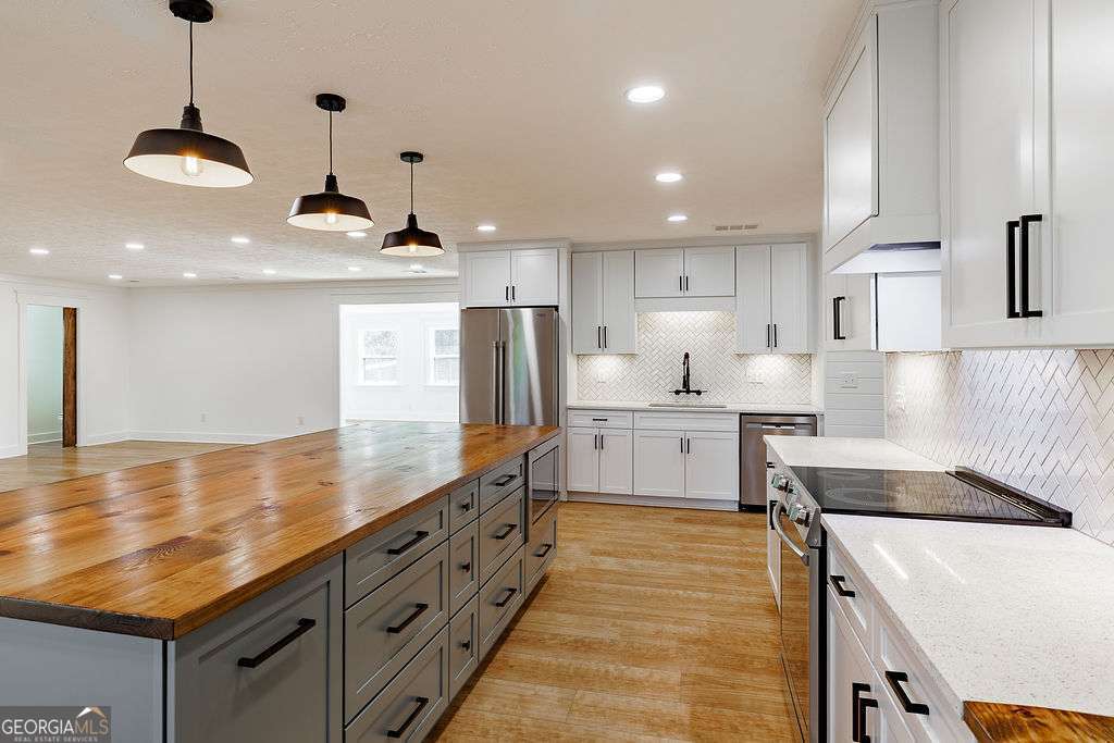 1410 Old Bishop Road Bishop, GA 30621 - Photo 13 of 73 a kitchen with kitchen island a sink stainless steel appliances and cabinets