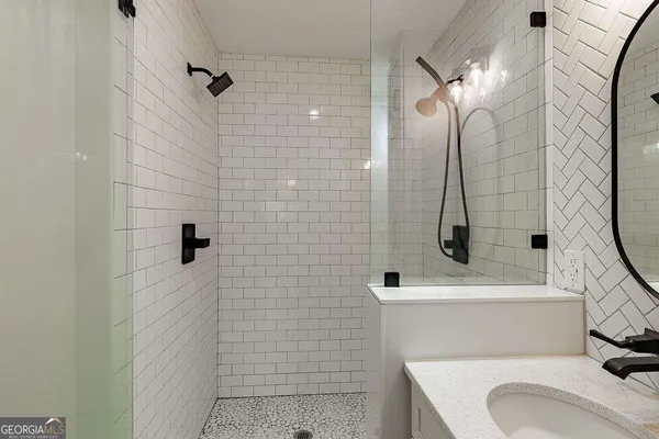 a view of a house with a large tree in front of it