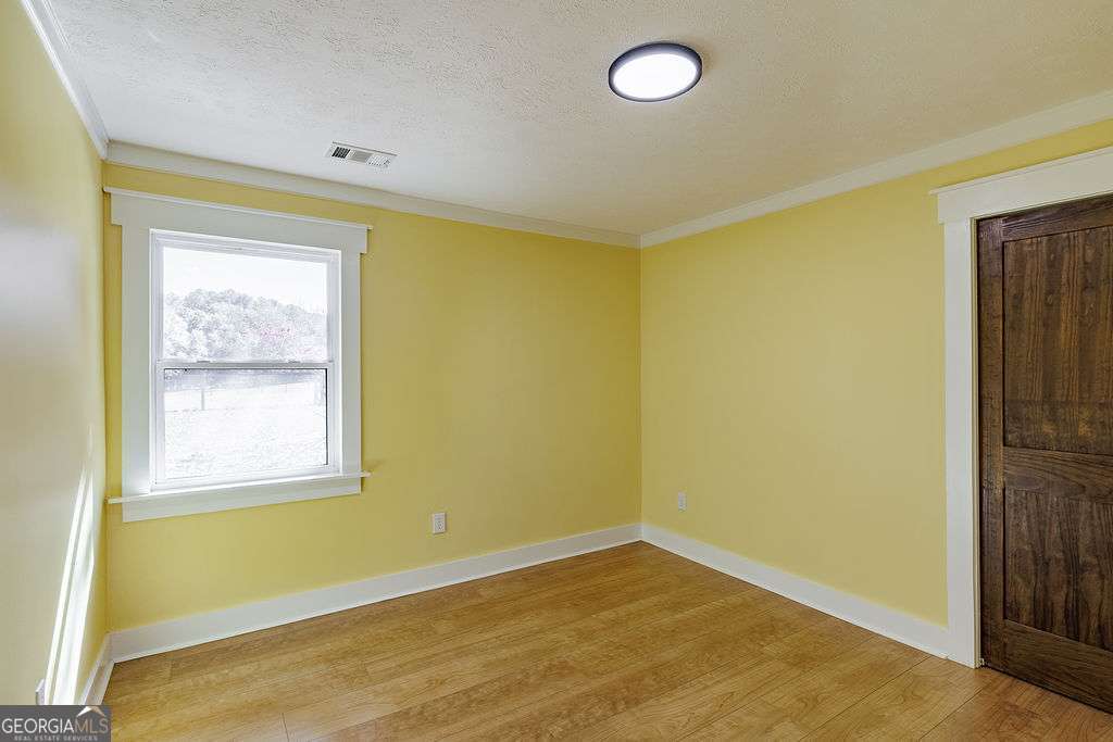 1410 Old Bishop Road Bishop, GA 30621 - Photo 35 of 73 a view of an empty room with wooden floor and a window