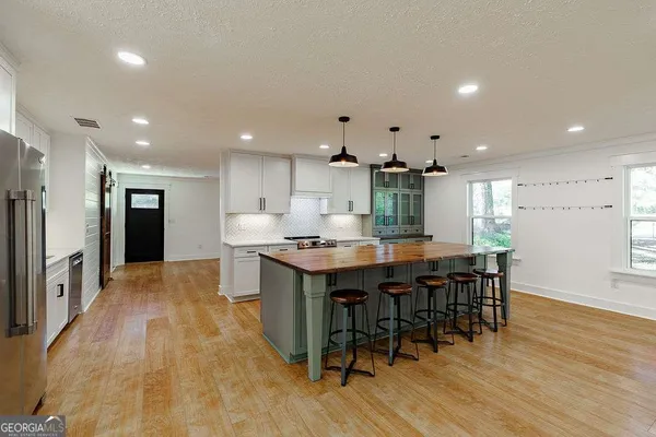 a kitchen with white cabinets and white appliances