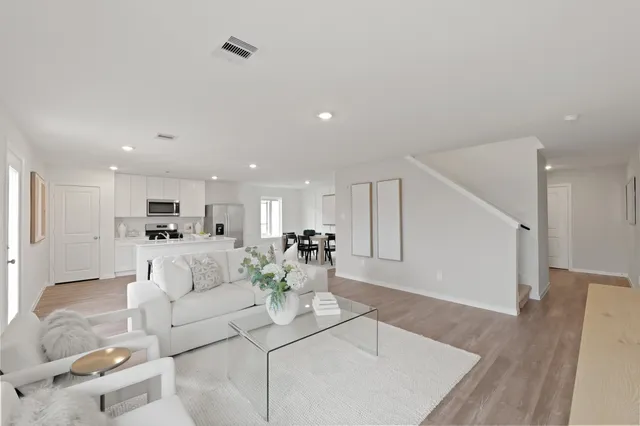 a living room with furniture and white walls