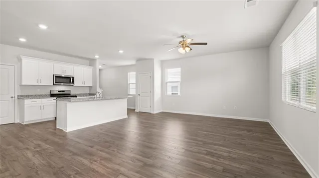 a view of kitchen with sink microwave and cabinets