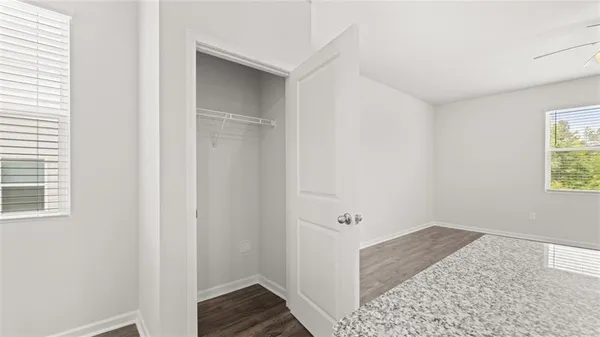 a view of hallway with window and hardwood floor