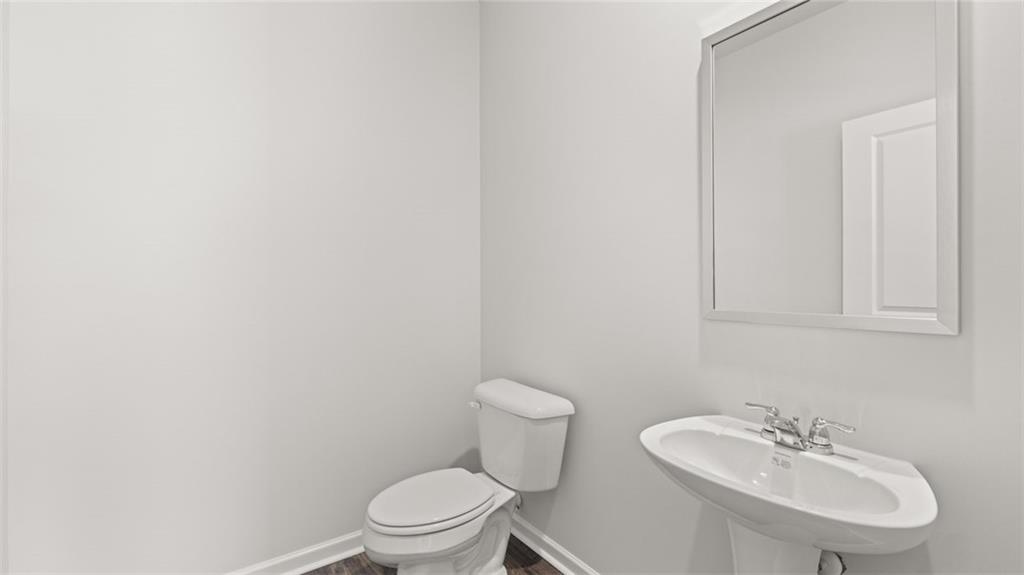 11923 Aukerman Way Hampton, GA 30228 - Photo 22 of 26 a bathroom with a sink a toilet and a mirror