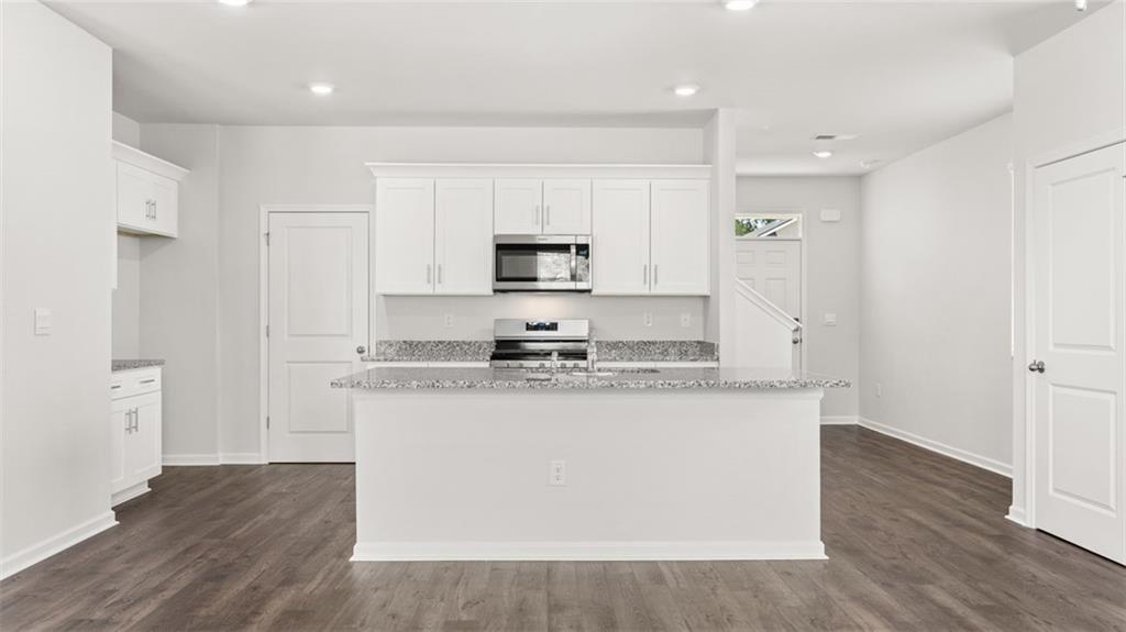 11923 Aukerman Way Hampton, GA 30228 - Photo 3 of 26 a kitchen with stainless steel appliances granite countertop a stove a sink and a refrigerator