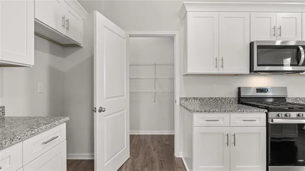 a kitchen with stainless steel appliances granite countertop a stove and a microwave