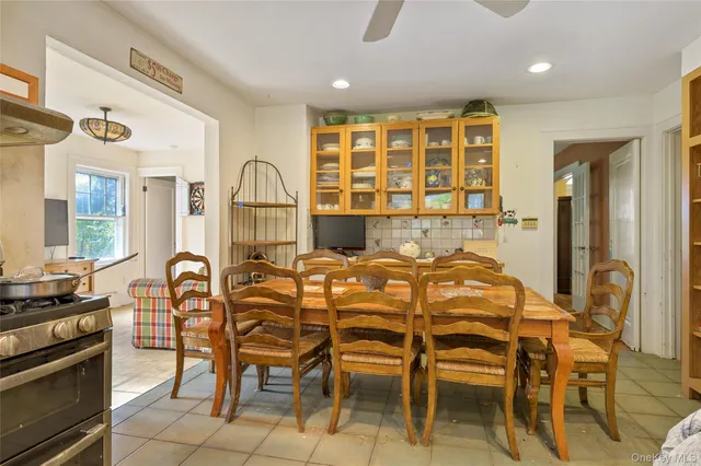 a dining room with furniture and a floor to ceiling window