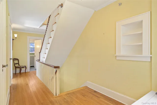 a view of a hallway view with wooden floor and staircase