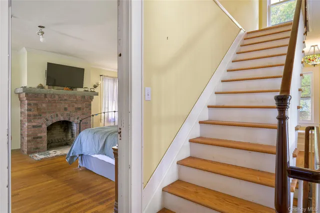 a view of entryway and hall with wooden floor