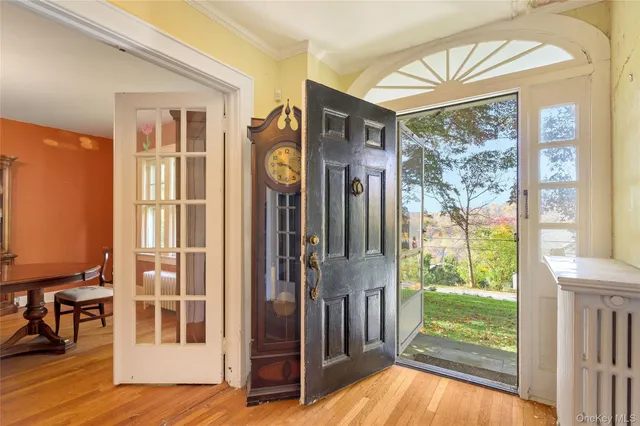 a view of front door and porch with wooden floor