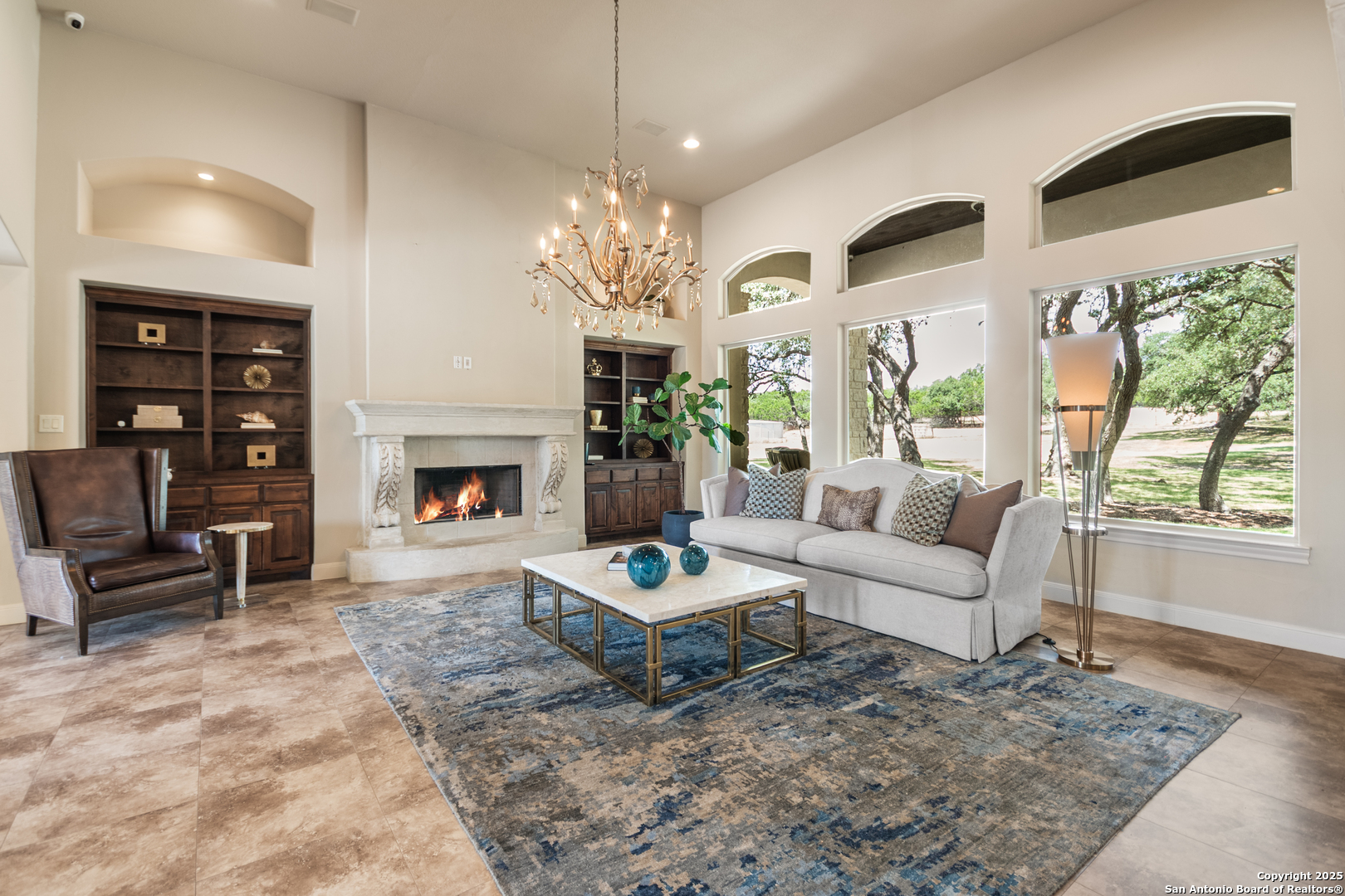 68 Brook Ridge Fair Oaks Ranch, TX 78015 - Photo 8 of 69 a living room with furniture a fireplace and a chandelier