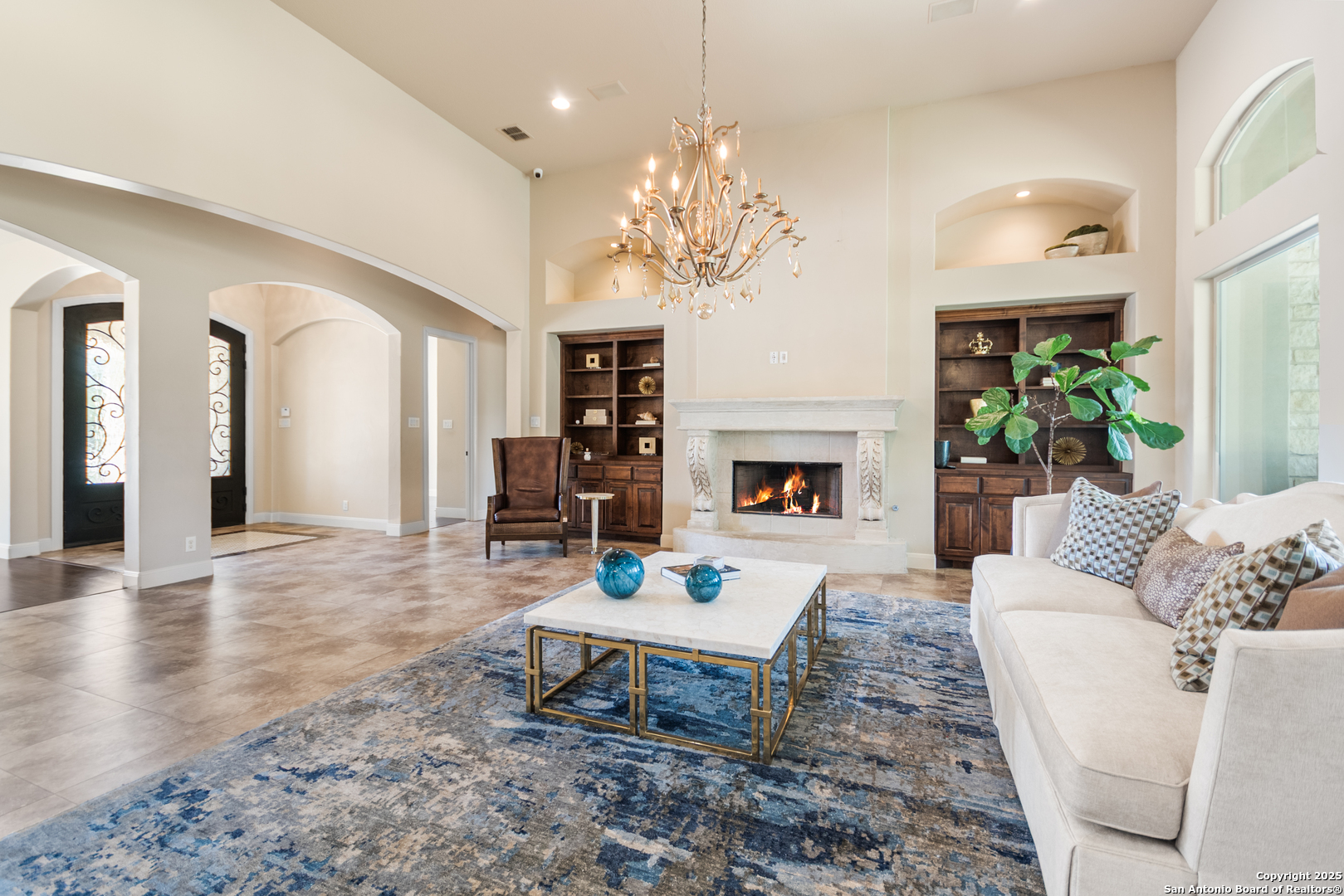 68 Brook Ridge Fair Oaks Ranch, TX 78015 - Photo 9 of 69 a living room with furniture a chandelier and a fireplace