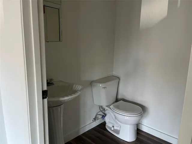 a white toilet sitting next to a sink